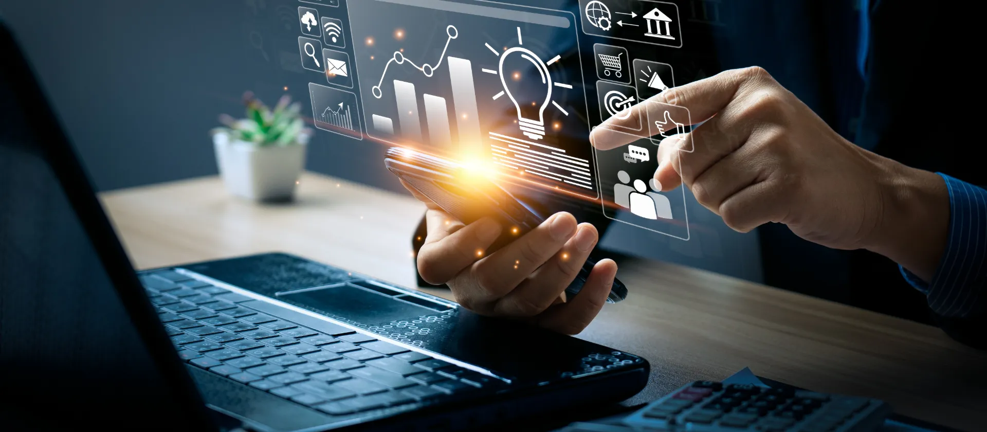 Hand holding a smartphone with digital analytics and marketing icons, while holographic data visualizations appear above a laptop – representing commercial excellence, digital transformation and digital health in the life sciences industry.