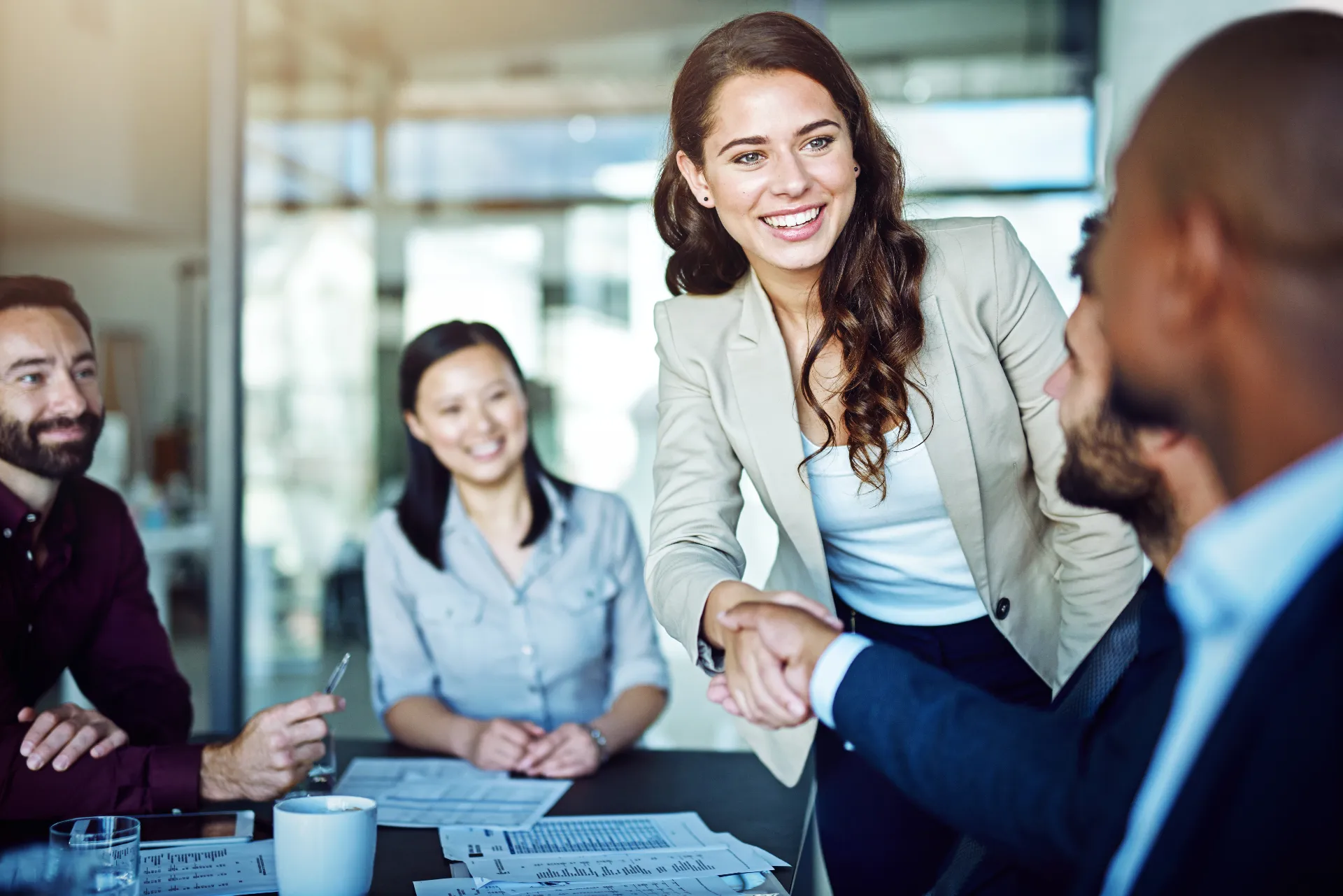 Symbolic image of corporate values Dedicated – team meeting with a handshake as a greeting.